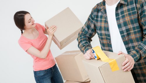 Professional movers carrying items in a flat removal